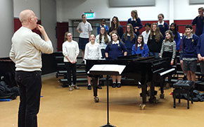 Don instructs a chorus at Tawa College in New Zealand